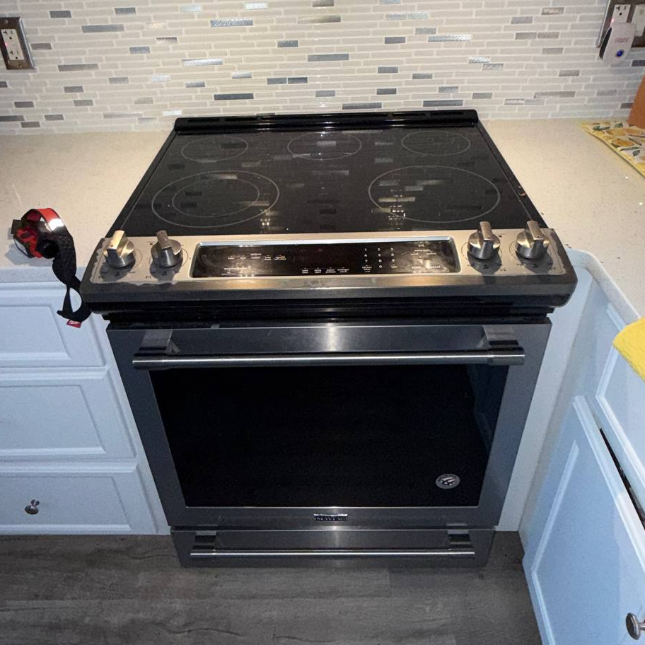 Electric range with glass cooktop during a range repair in Fort Myers